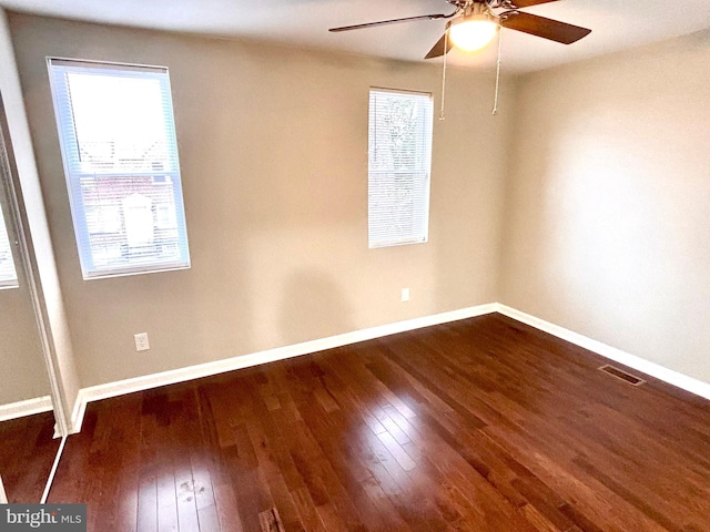 unfurnished room featuring ceiling fan and dark wood-type flooring