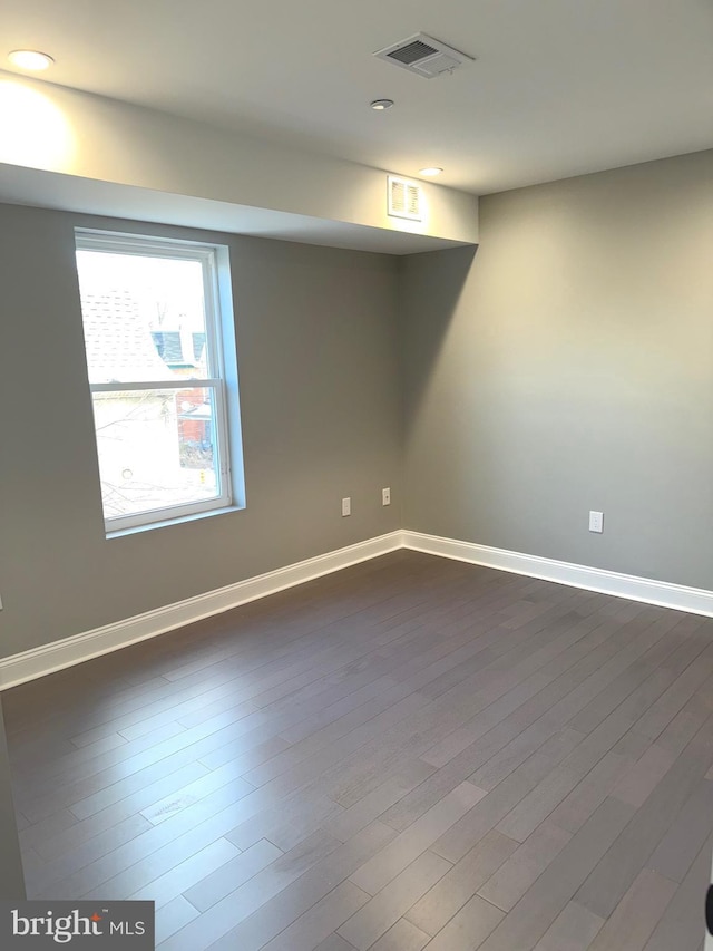 spare room with dark hardwood / wood-style floors