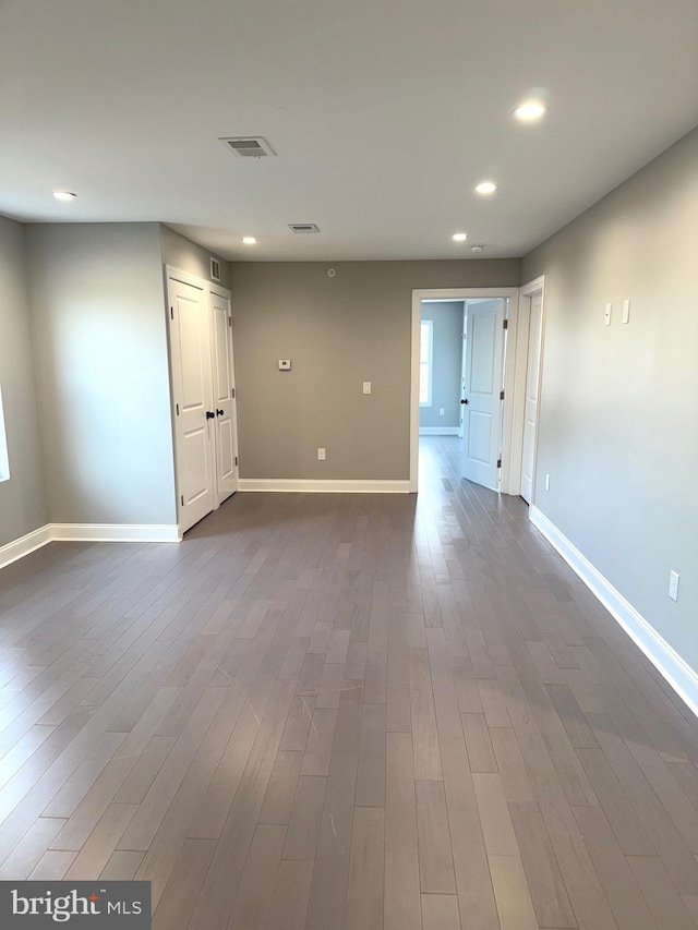 unfurnished room featuring dark wood-type flooring