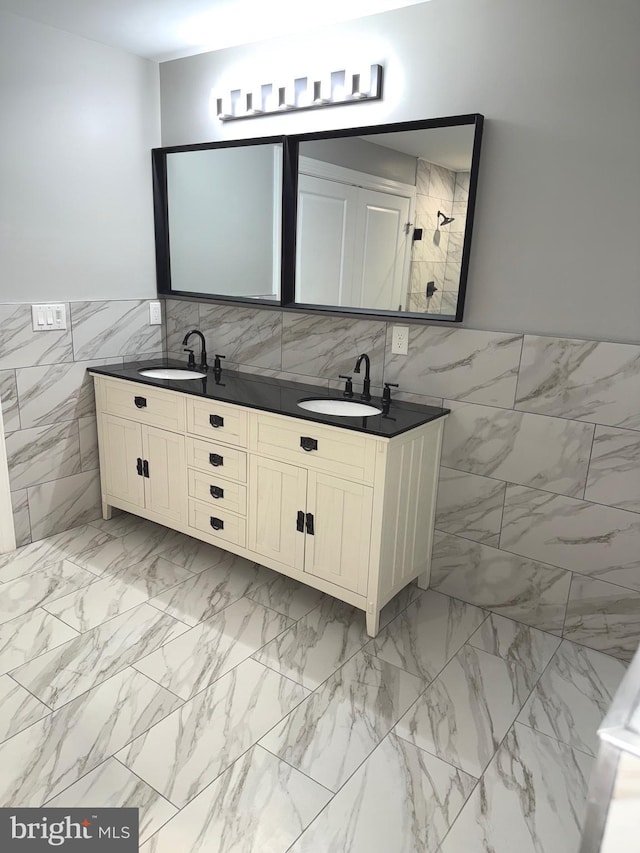 bathroom with vanity and tile walls