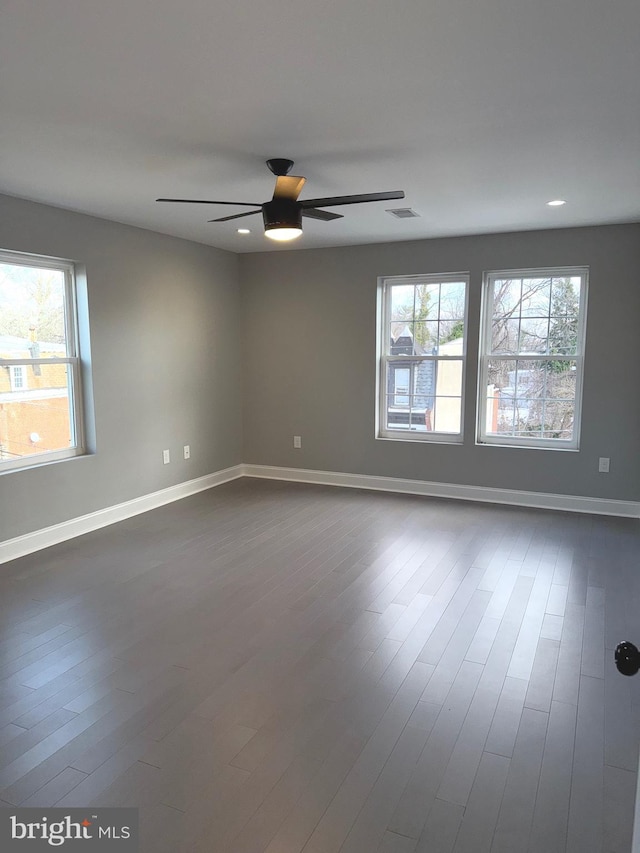 empty room featuring hardwood / wood-style flooring and ceiling fan