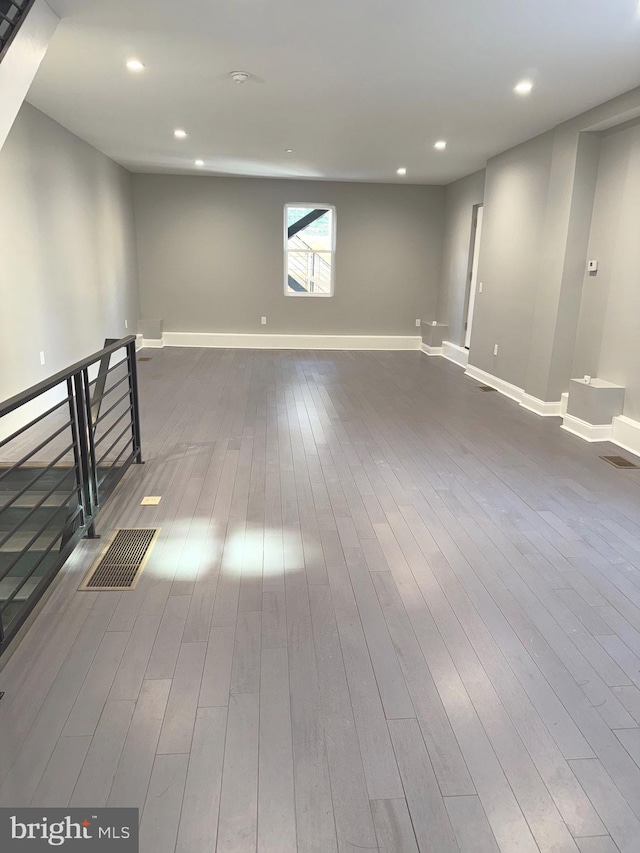 basement with dark hardwood / wood-style floors