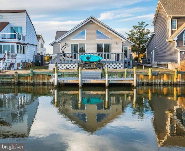 rear view of house with a deck with water view