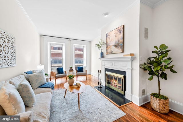 living room featuring crown molding and hardwood / wood-style floors