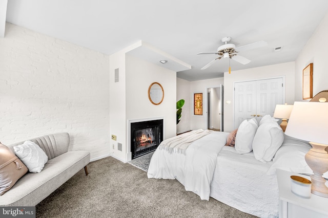 carpeted bedroom with ceiling fan and a closet