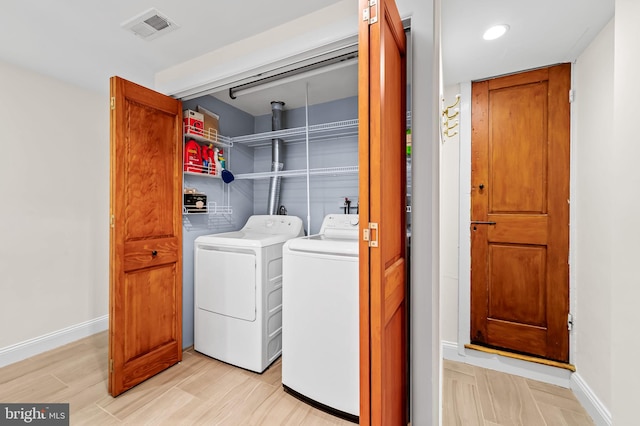 clothes washing area with washer and clothes dryer