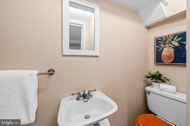 bathroom featuring sink and toilet