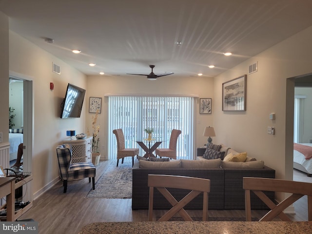 living room with ceiling fan and wood-type flooring