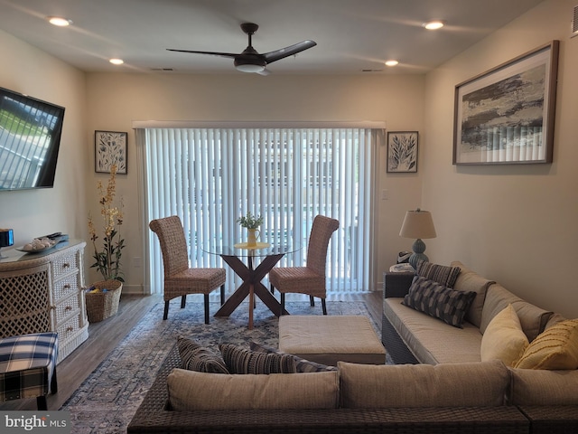 living room featuring ceiling fan and dark hardwood / wood-style floors