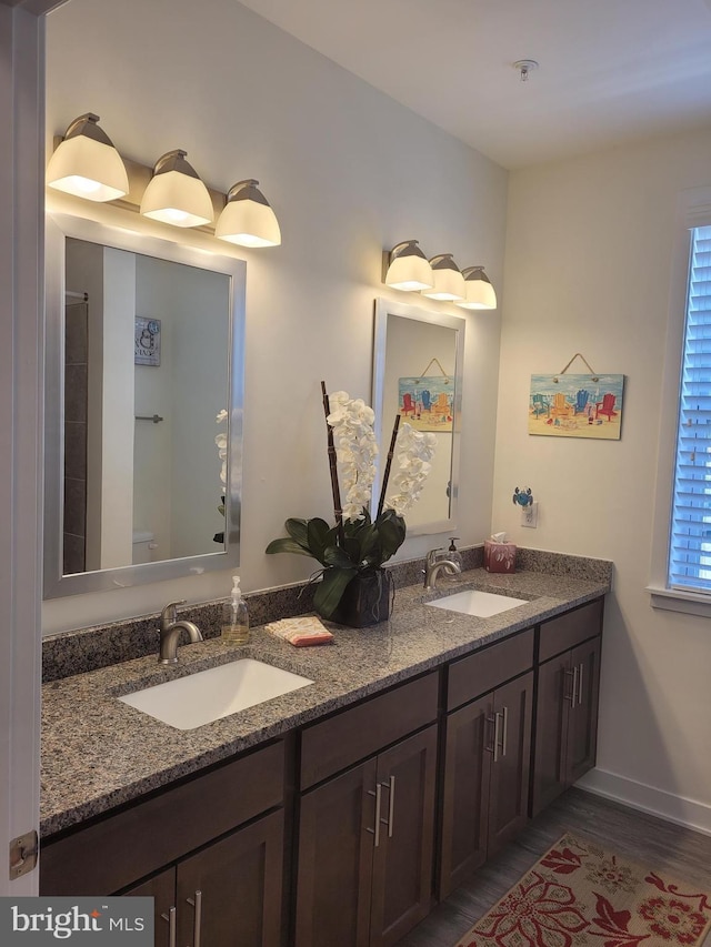 bathroom with wood-type flooring, vanity, and toilet