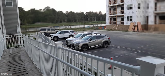 view of vehicle parking featuring a water view