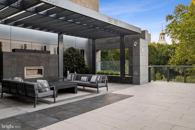 view of patio featuring an outdoor living space with a fireplace