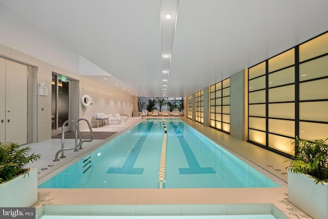 view of swimming pool with elevator