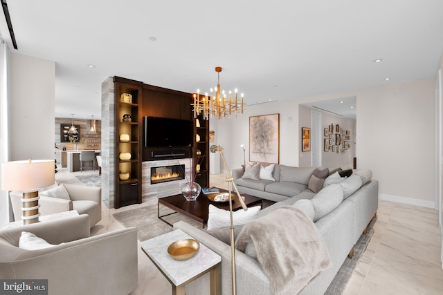 living room featuring an inviting chandelier and a high end fireplace