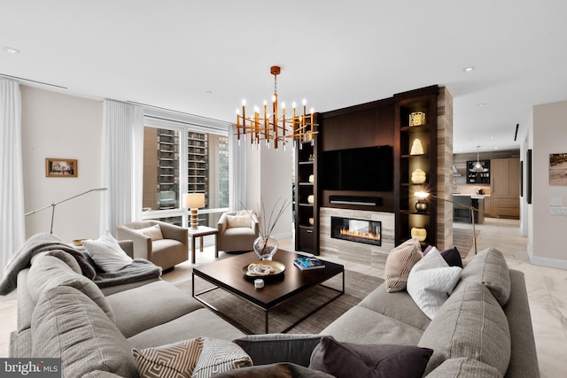 living room featuring an inviting chandelier and a fireplace