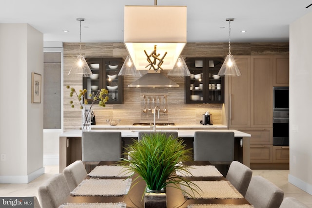 bar featuring tasteful backsplash, light tile patterned flooring, pendant lighting, and gas stovetop