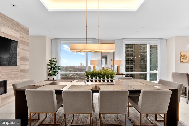 dining area featuring a wall of windows and a high end fireplace