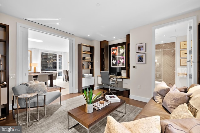 living room featuring wood-type flooring and built in desk