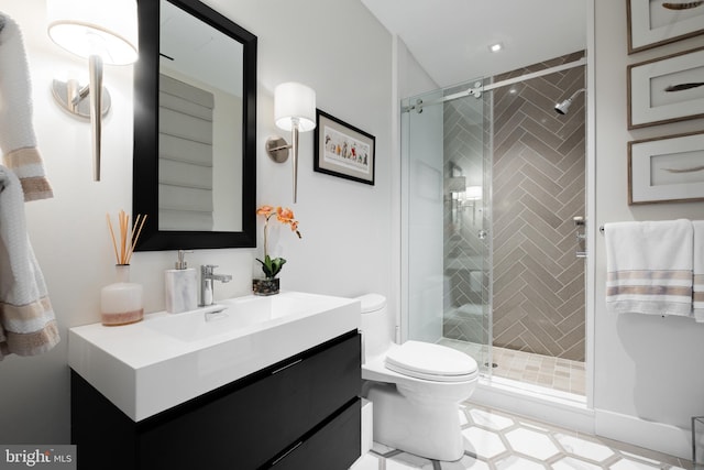 bathroom with vanity, an enclosed shower, and toilet