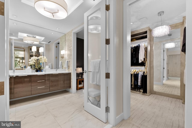 bathroom with vanity and a notable chandelier