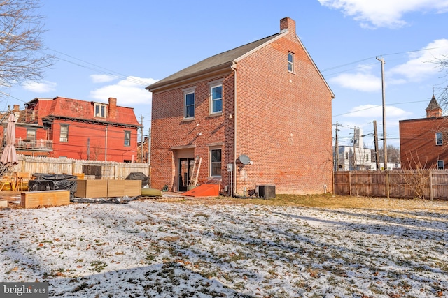 snow covered house with central AC unit