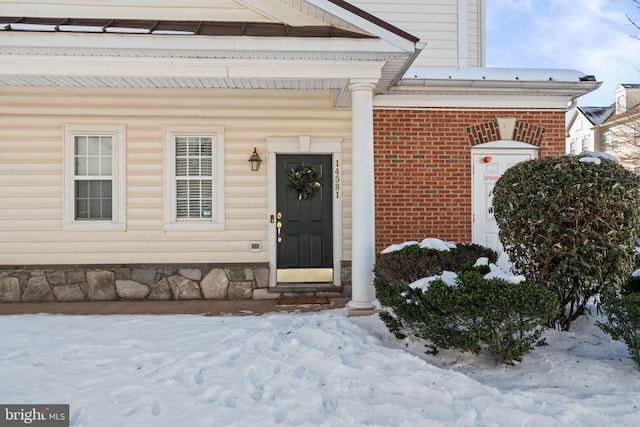 view of snow covered property entrance