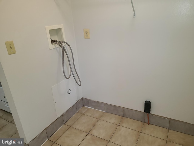 washroom with washer hookup and light tile patterned floors