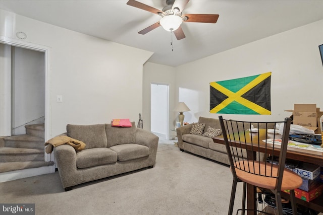 carpeted living room with ceiling fan