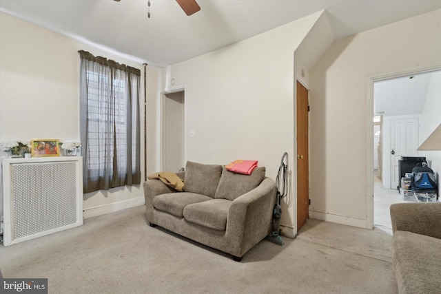 interior space with ceiling fan and light carpet