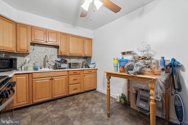 kitchen with stainless steel range, ceiling fan, tasteful backsplash, and sink