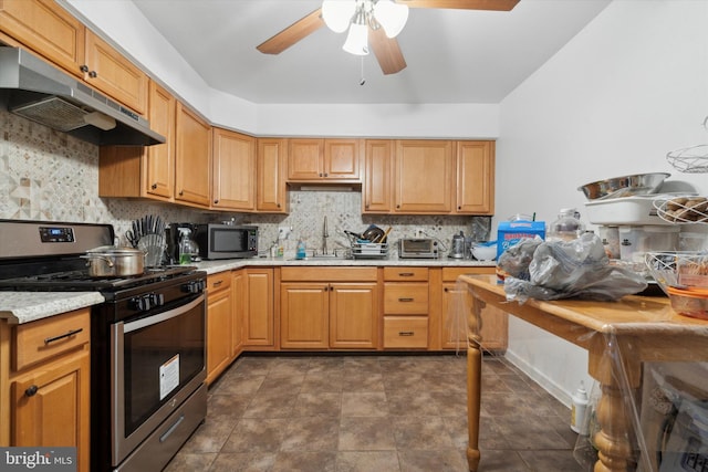 kitchen featuring appliances with stainless steel finishes, ceiling fan, backsplash, and sink