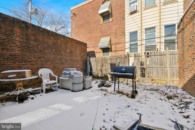 snow covered patio featuring area for grilling