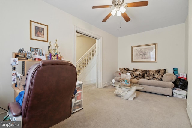 carpeted living room with ceiling fan