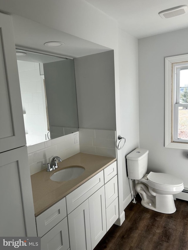 bathroom with vanity, hardwood / wood-style floors, and toilet