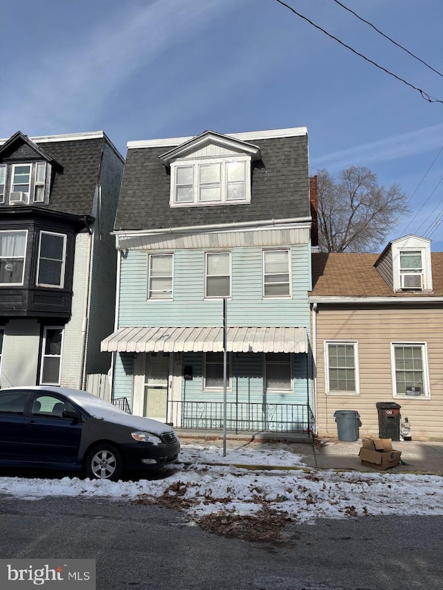 view of front of property with a porch and cooling unit