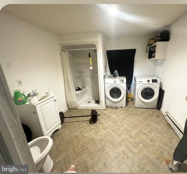 laundry area featuring washer and clothes dryer and a baseboard heating unit