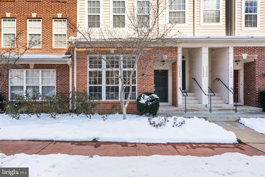 view of snow covered property entrance