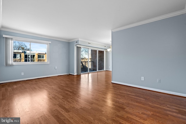 unfurnished room with hardwood / wood-style flooring, a chandelier, and ornamental molding