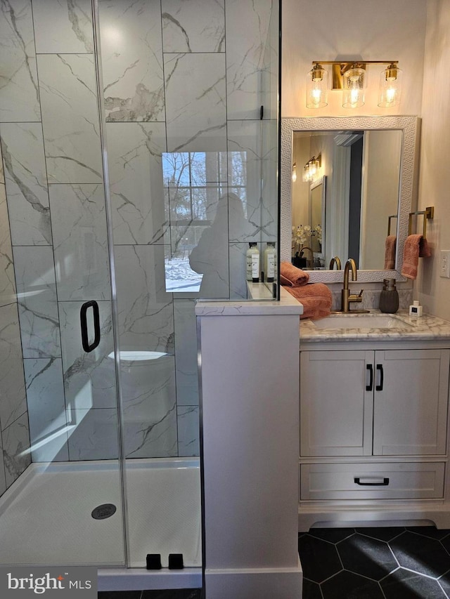 bathroom with an enclosed shower and vanity