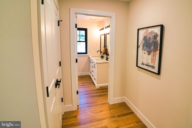 hallway with light hardwood / wood-style flooring