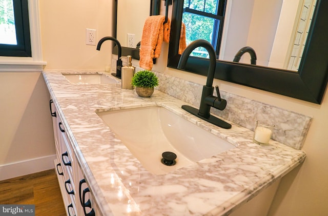 bathroom featuring hardwood / wood-style flooring and vanity