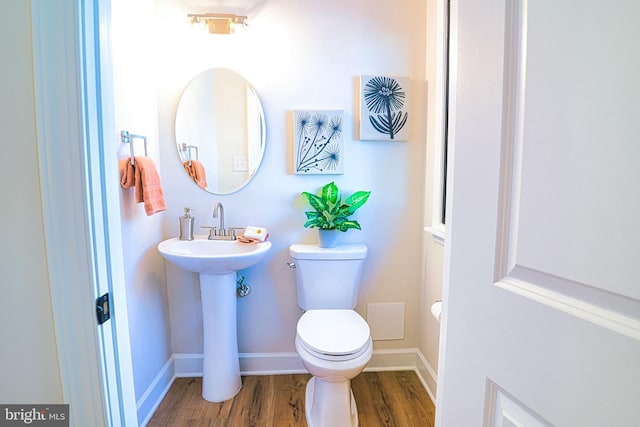 bathroom featuring sink, hardwood / wood-style floors, and toilet