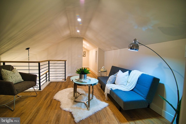 sitting room with lofted ceiling and wood-type flooring