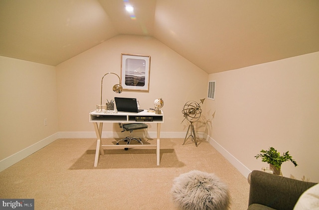 carpeted home office featuring vaulted ceiling