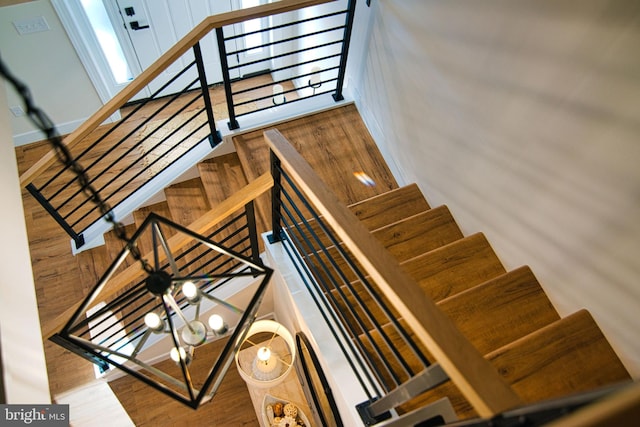 stairway with a chandelier