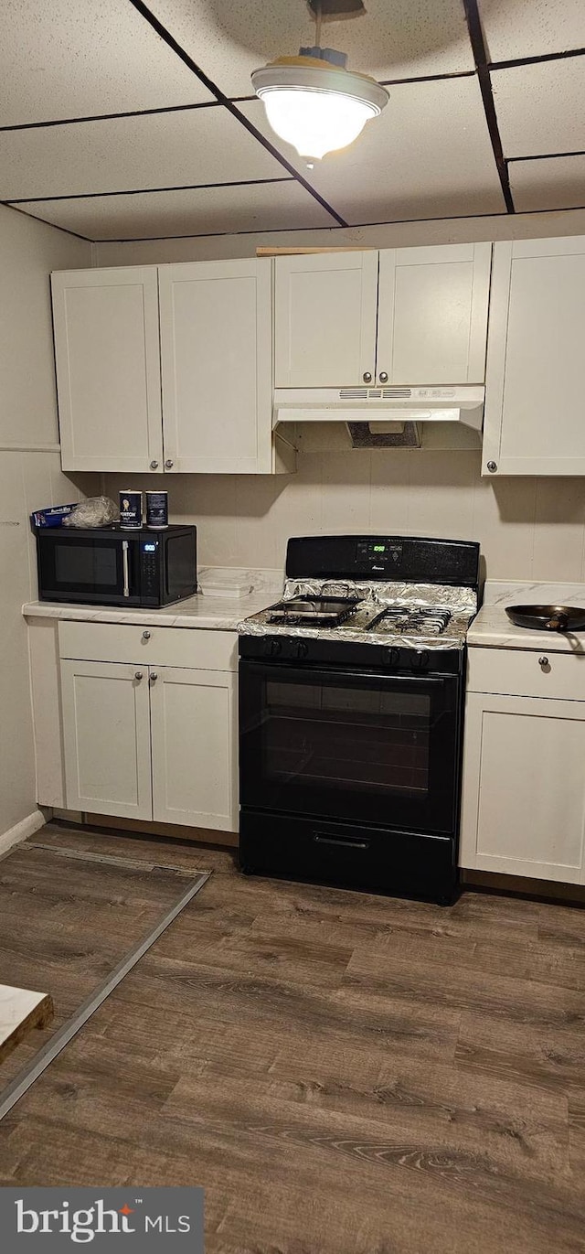 kitchen featuring black appliances, dark hardwood / wood-style floors, and white cabinetry