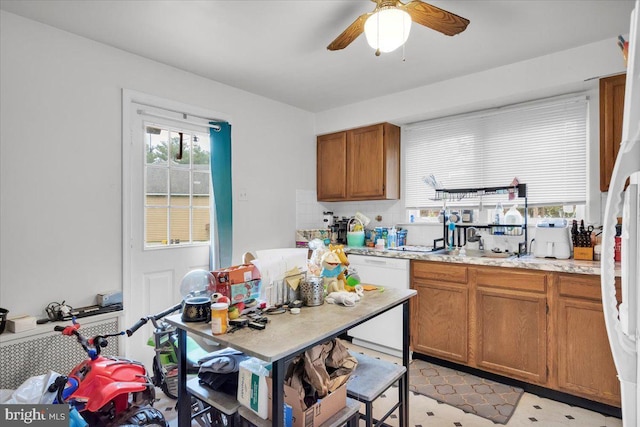 kitchen with decorative backsplash, white appliances, ceiling fan, and sink