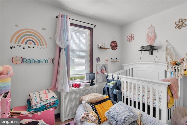 bedroom featuring a nursery area