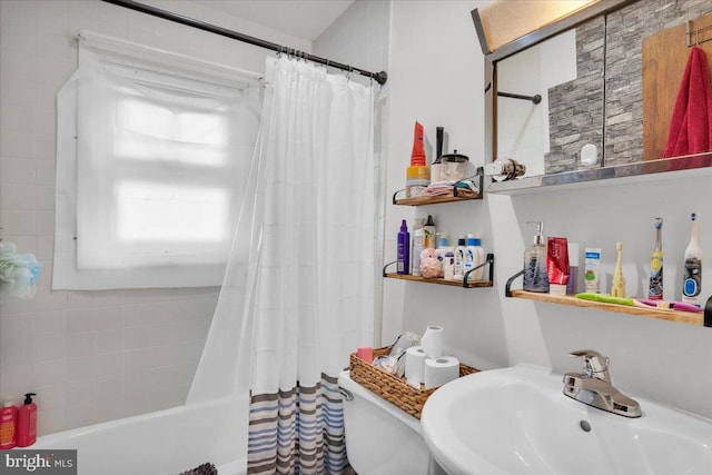 bathroom featuring sink and shower / bathtub combination with curtain