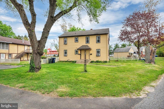 colonial-style house with a front lawn